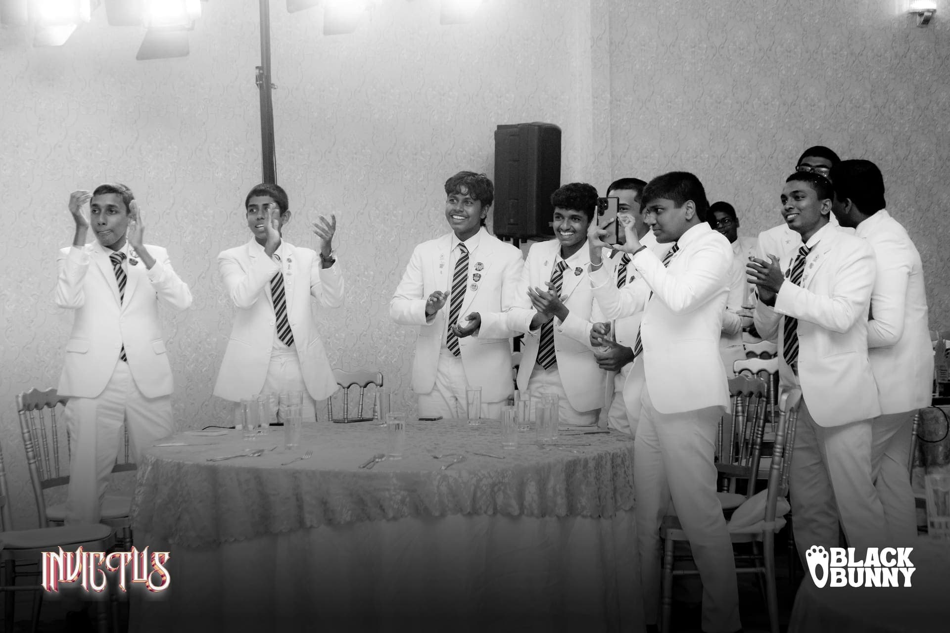 The club on its feet cheering, in black and white